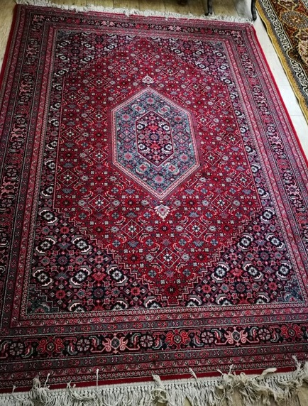 A Persian red ground rug 235 x 170cm